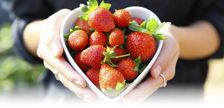 Heart shaped bowl full of strawberries