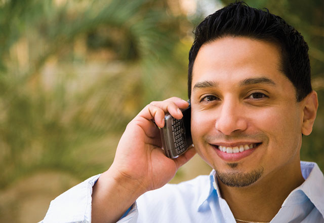 man talking on phone while smiling