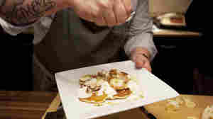Voltaggio sprinkles sugar on granola pancakes, a dish from his new cookbook, Home.