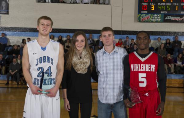 Family members of Matt O'Mahony and Glenn Wall present awards to the 2014 memorial game MVPs.  Pictured (Left to Right): Jimmy Hammer, A&S '14; Avery Wall; Robert O'Mahoney, Jr.; and Malique Killing from Muhlenberg college.