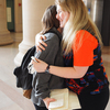 TMAYD founder Izzy Lloyd (right) gives a friend a hug after asking about her day.