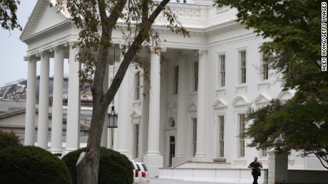 WASHINGTON, DC - SEPTEMBER 29:  A member of the U.S. Secret Service patrols outside the North Portico of the White House September 29, 2014 in Washington, DC. Omar Gonzalez, the man arrested on Friday after jumping the White House fence, went deeper into the building than what it was previously reported.  (Photo by )
