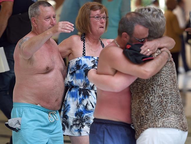 Tragecy ... tourists console each other following a shooting in the resort town, Sousse. 