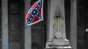 Confederate flag supporters gather at the South Carolina Statehouse in Columbia; the state's Senate voted Tuesday to take down the flag. The issue will now head to the House.
