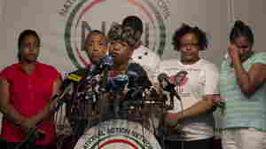 Gwen Carr, the mother of Eric Garner, speaks at a news conference at the National Action Network in New York a day after settling a $5.9 million wrongful death case with the city. At far right is Garner's widow, Esaw Garner.