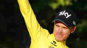 Team Sky rider Chris Froome of Britain, with the race leader's yellow jersey, celebrates his overall victory on the podium after the 109.5-km (68 mile) final 21st stage of the 102nd Tour de France.