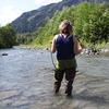 KUOW reporter Ashley Ahearn wades into the Elwha River.