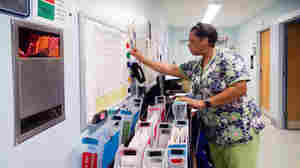 Nursing attendant Tracie Bell helps manage patients at the ophthalmology clinic at Los Angeles County Harbor-UCLA Medical Center. The clinic created a color-coded system to reduce wait times for patients.
