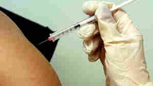 A teenage girl gets a shot of HPV vaccine, which protects against a virus that causes cervical cancer.