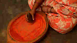 A woman prepares bhasma ingredients for an Ayurvedic treatment in India. Ayurveda is also used in the United States.