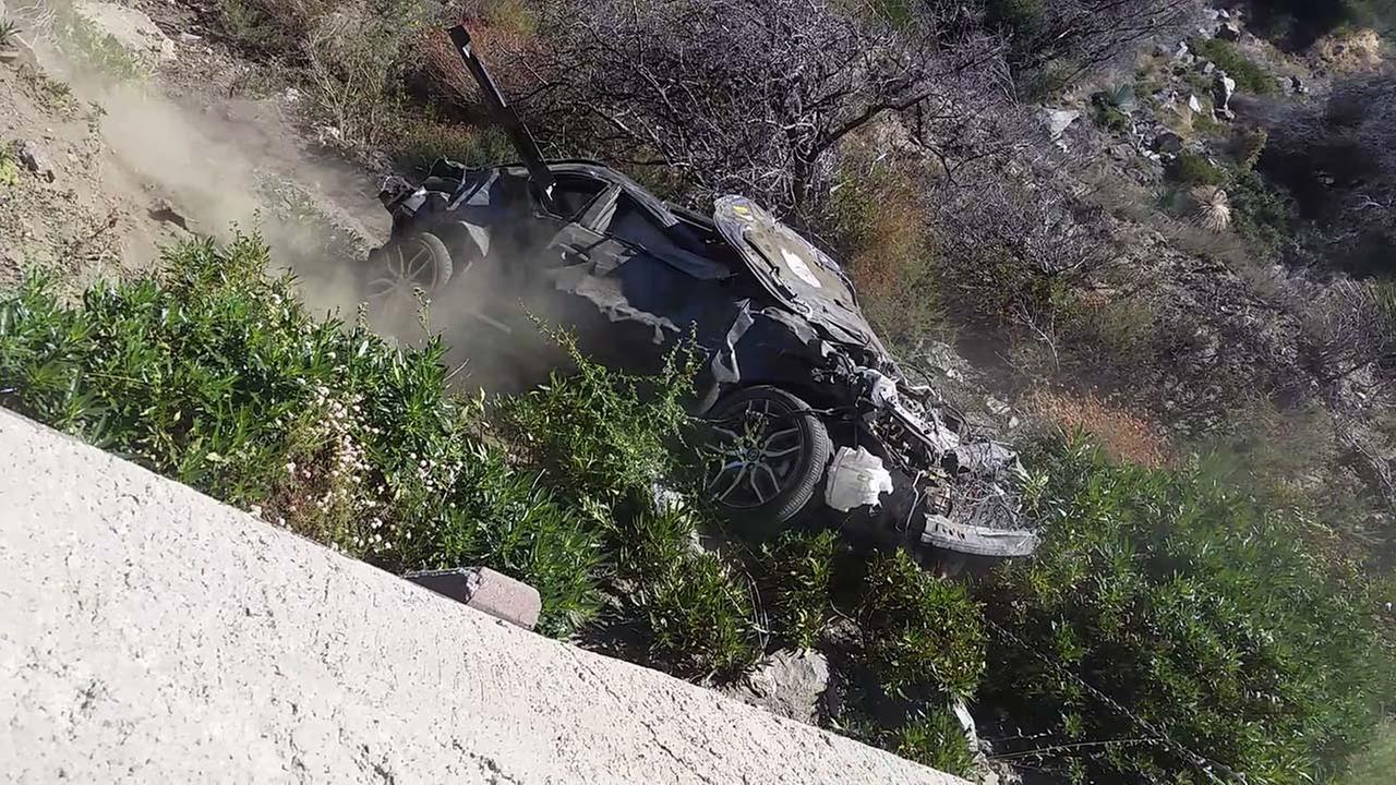 A tow truck pulls a car that rolled over back onto the Angeles Crest Highway on Sunday, Aug. 9, 2015.