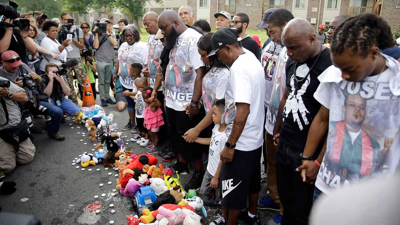 Michael Brown Sr. along with family and friends stop to pray at a memorial to Browns son before taking part in a parade in his sons honor on Aug. 8, 2015, in Ferguson, Mo.