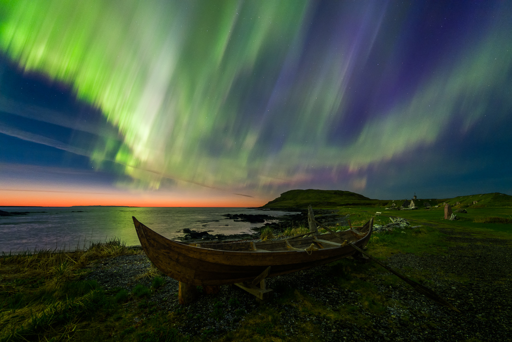 Viking Lights. L'anse aux Meadows, Newfoundland, Canada. Nikon D810A, Nikon 14-24mm f/2.8 lens @ 14mm. Sky: Single shot at ISO 3200, f/2.8, 1 second. Foreground: Single shot at ISO 1600, 14mm, f/5.6, 2 minutes. Photo by Adam WoodworthWe first became acquainted with Adam Woodworth when we featured his portfolio earlier this year. His photos capture the interplay between the earthly and the celestial, often framing the center of the Milky Way Galaxy in alignment with landscape formations. Recently he&rsquo;s been trying out Nikon&rsquo;s D810A, the world&rsquo;s first full frame camera dedicated to astrophotography.So what&rsquo;s different about a camera designed for astrophotography? Most cameras&rsquo; Infrared filters are rather broad-ranging and filter out some visible red light, as well as IR. The filter on the D810A is much more precise, meaning the camera is around four times more sensitive to long-wavelength red light than an ordinary DSLR.This makes it much more able to capture the Hydrogen Alpha spectral line (656nm): the precise color emitted by the hot clouds of Hydrogen gas that occur in emission nebulae. The modification won&rsquo;t make much of a difference when shooting sunlight reflected off the moon or planets, though the character of the filter means it&rsquo;s likely to give a reddish tinge to ordinary photography under certain circumstances. See some of Adam Woodworth&rsquo;s photos from the D810A and find out his impressions on using it.