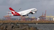 Qantas flies back into the black