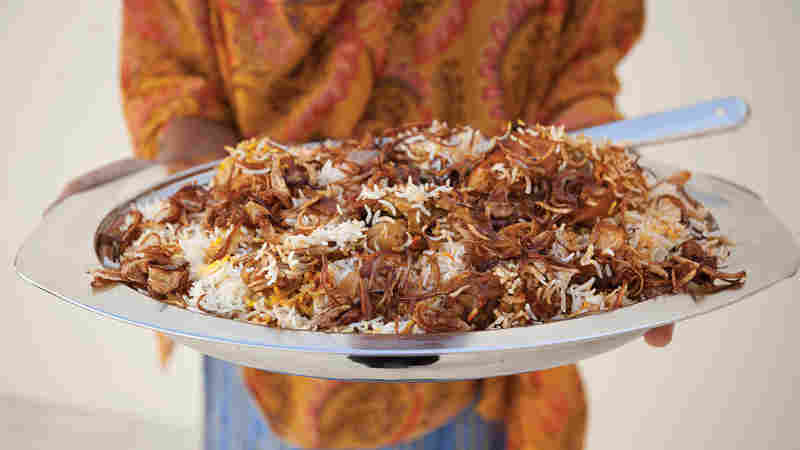 Zanzibari biryanai, a dish involving spiced poached chicken, fried onions, a rich gravy and rosewater- and saffron-scented rice. Zanzibar was part of Oman until 1965.