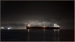 Freighter At Anchor In The Fog