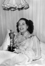 Best Actress Joan Crawford ("Mildred Pierce") with her award at home, awarded to her at the 18th Academy Awards.