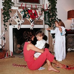 Jacqueline Kennedy holds her nephew as her daughter watches during the family Christmas Eve gathering in 1962 (JFKL)