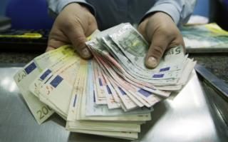 a wad of euro notes, in woman's hands