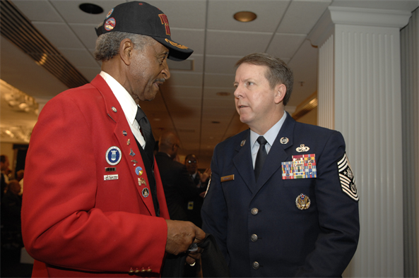 Tuskegee Airman Ezra Hill speaks with Chief Master Sergeant of the Air Force Rodney McKinley Jan. 20 at the Bolling Club on Bolling Air Force Base, D.C. More than 180 Tuskegee Airmen and their families gathered for a special breakfast before being bused downtown for the 2009 inaugural events.  (U.S. Air Force photo by Senior Airman Tim Chacon)