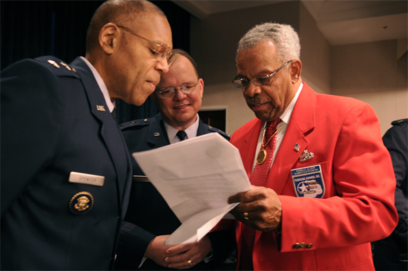 Maj. Gen. Larry Spencer (left), director of the Air Force Budget, and Maj. Gen. Bruce Green, deputy surgeon general, speak with Donald E. Elder, an original Tuskegee Airman Jan. 20 at the Bolling Club on Bolling Air Force Base, D.C. More than 180 Tuskegee Airmen and their families gathered for a special breakfast before being bused downtown for the 2009 inaugural events. (U.S. Air Force photo/Staff Sgt. Dan DeCook)