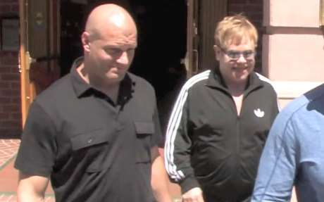 Sir Elton John is pictured with his former bodyguard Jeffrey Wenninger (wearing a black shirt) in Beverly Hills in April 2014. 