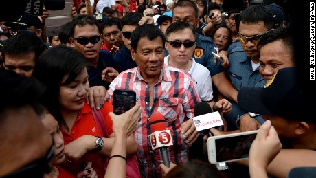 Presidential frontrunner and Davao City Mayor Rodrigo Duterte leaves the voting precint after casting his vote at Daniel Aguinaldo National High School in Davao City, on the southern island of Mindanao on May 9, 2016.
