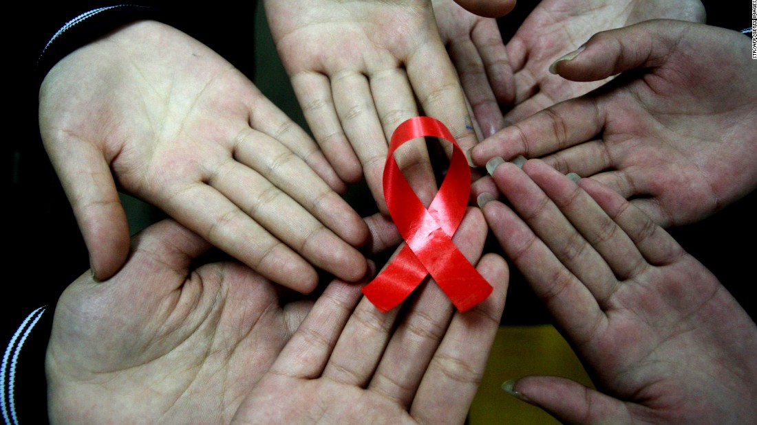 File photo: Chinese students show a handmade red ribbon one day ahead of the the World AIDS Day, at a school in Hanshan, east China&#39;s Anhui province on November 30, 2009. 
