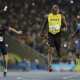 Usain Bolt from Jamaica, center, celebrates after crossing the line to win the gold medal in the men's 200-meter final.