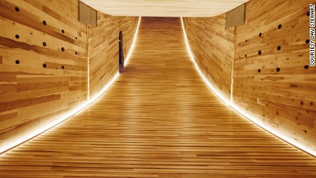 The interior of &quot;The Smile&quot; by night. The structure showcases the structural and spatial potential of cross-laminated American tulipwood. Alison Brooks&#39; concept is the first ever mega-tube made with construction-sized panels of hardwood CLT.