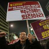 South Korean protesters shout slogans as they march after a rally calling for South Korean President Park Geun-hye to step down in downtown Seoul, South Korea, Saturday, Nov. 5, 2016.