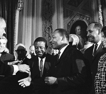 President Lyndon B. Johnson shakes hands with Dr. Martin Luther King after signing the Voting Rights Act. (LBJ Library photo by Yoichi Okamoto)