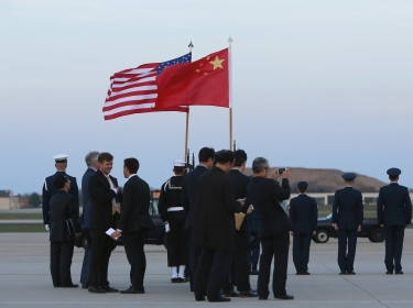 A diplomatic delegation waits for China's President Xi Jinping to arrive at Joint Base Andrews, Maryland, March 30, 2016, to attend the Nuclear Security Summit in Washington