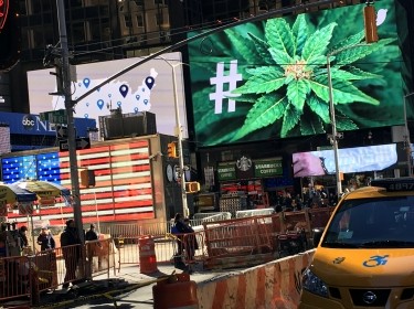 An electronic billboard displays a marijuana hashtag at Times Square in New York, November 7, 2016