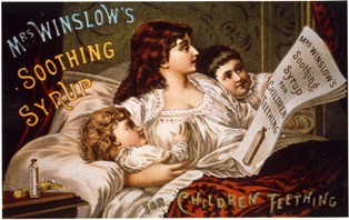 A lady in bed with a little girl on the right and a little boy on the left. She is reading a piece of paper with says, 