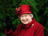 Britain's Queen Elizabeth II waves as she arrives for the final day of the Cheltenham Festival horse racing meeting in Gloucestershire, western England March 13, 2009.