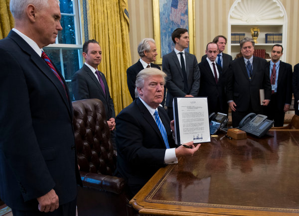 President Trump, in the Oval Office in January, showing his signature on the global “gag rule” on abortion.