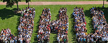 picture of people arranged to spell JHU