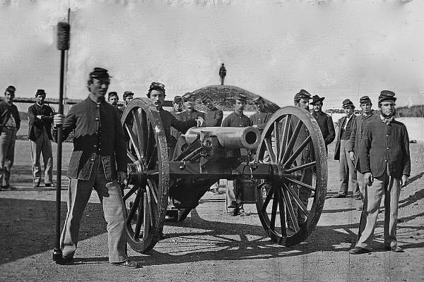 Artillery Team, One soldier holds the sponge by a large mobile cannon.
