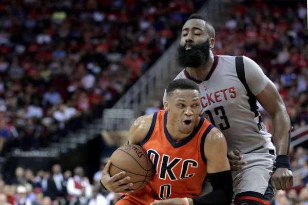 Oklahoma City Thunder's Russell Westbrook (0) is fouled as he drives around Houston Rocket' James Harden (13) during the first half of an NBA basketball game in Houston, Sunday, March 26, 2017. (AP Photo/Michael Wyke)