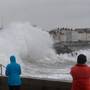 Walkers watch the big waves this month in Dún Laoghaire, Co Dublin. Photo: Justin Farrelly