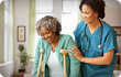 nurse helping woman on crutches