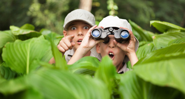 Boy with binoculars photo via Shutterstock
