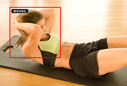 Trainer showing improper form for crunches
