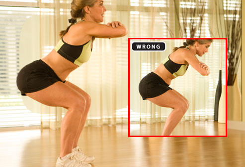 Trainer demonstrating proper form for squats