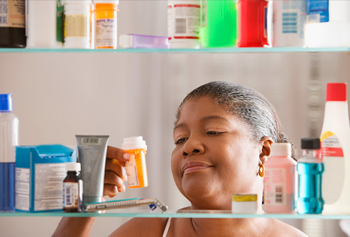 Woman examining prescription bottle