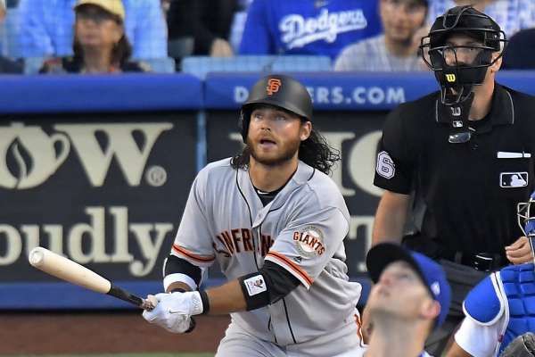 San Francisco Giants' Matt Moore watches his solo home run off Los Angeles Dodgers starting pitcher Alex Wood, front,  during the second inning of a baseball game, Friday, July 28, 2017, in Los Angeles. (AP Photo/Mark J. Terrill)