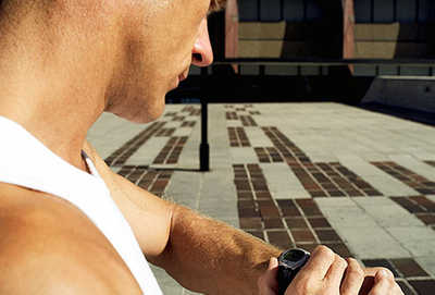man looking at his watch before a workout