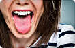 close up of woman sticking out tongue