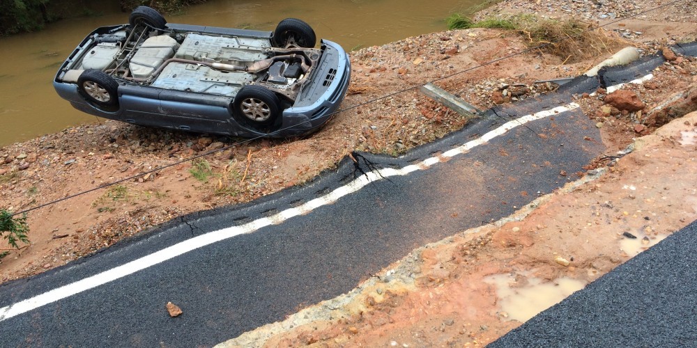 Road collapse in Lugoff, SC on October 5, 2015. The blue vehicle in the background is where the woman was rescued last night and the male DOT was recovered this morning.